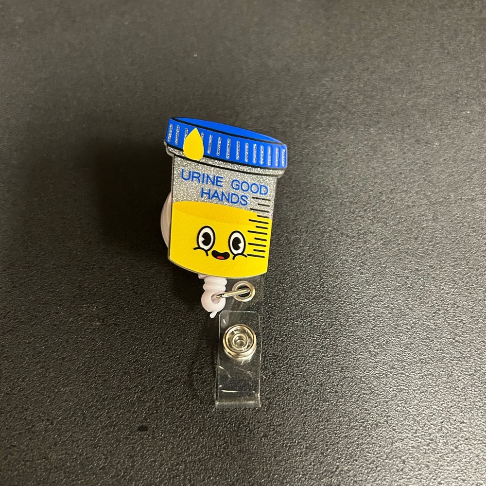 6 piece Lot of Fun Badge Reel with Urine Good Hands Design